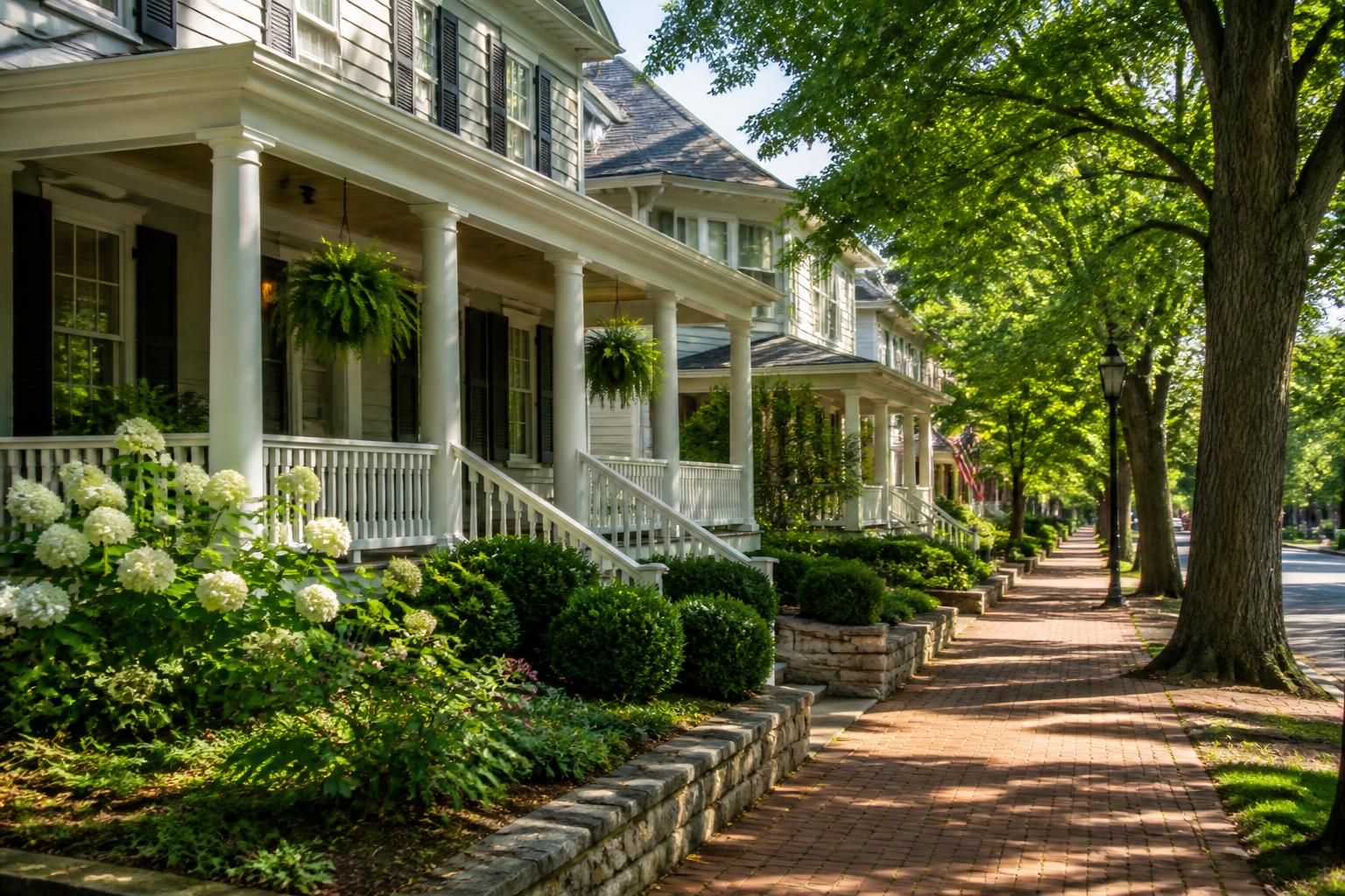 Classic neighborhood with traditional homes and shaded sidewalks.
